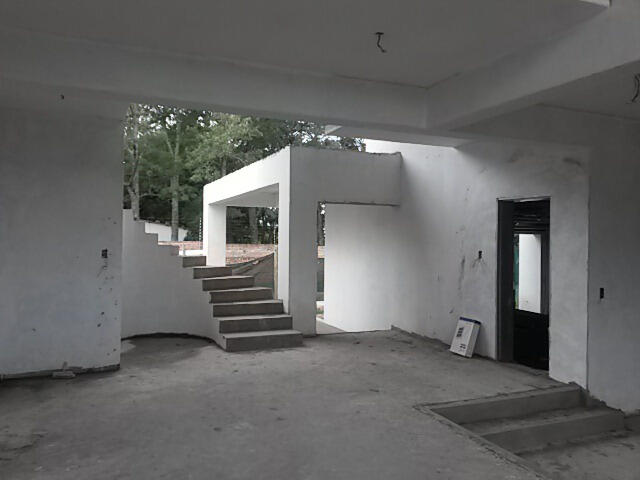 Interior stairway and ceiling framework paving the way for modern finishes.